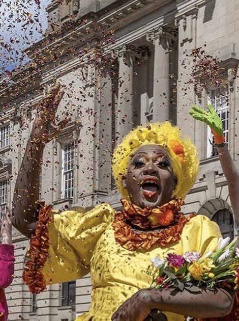 Yshee Black in a yellow gown under falling confetti