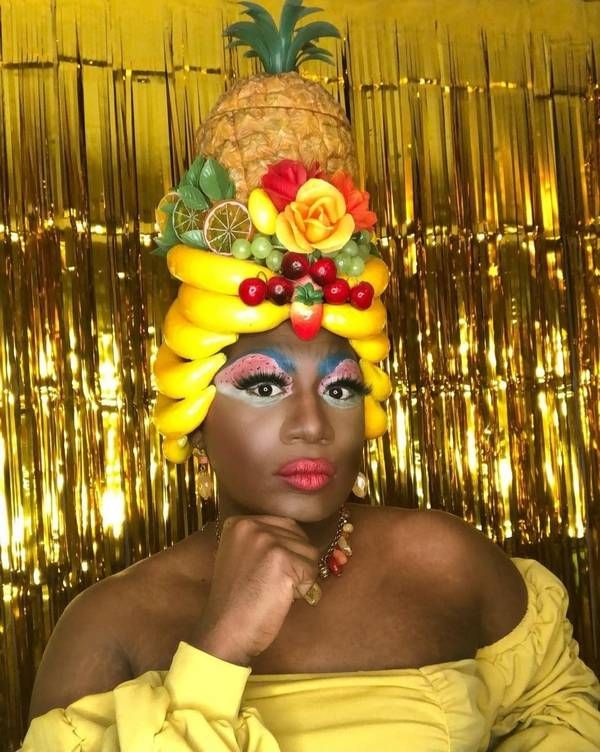 Yshee Black wearing a fruit-basket headpiece